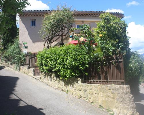 a house with a fence next to a street at L'insouciance, a cottage in Provence in La Celle-sous-Gouzon