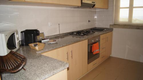 a kitchen with a stove and a counter top at Alojamento Rural de Vales in Vales