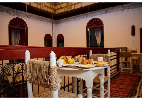 a white table with food on top of it at Riad Dar Iman in Fès