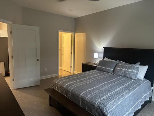 a bedroom with a bed with a blue comforter at The Buford T Justice Suite in Lexington