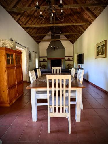 a dining room with a wooden table and chairs at Secluded Fynbos Retreat in Piketberg