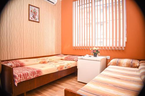 a small room with two beds and a window at къща за гости Велина in Pavel Banya