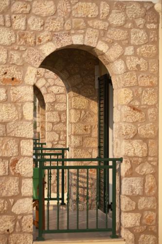 a stone building with a gate in front of a door at Element Hotel in Elafonisos