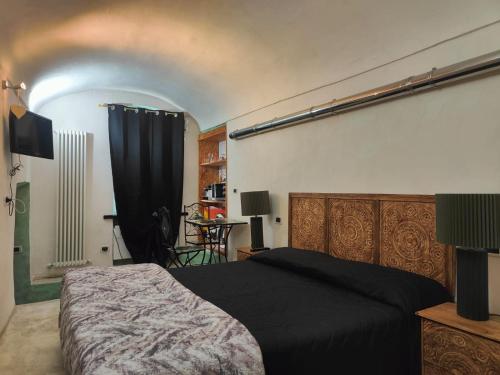a bedroom with a bed with a black blanket at Casa Norida in Bordighera