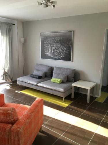 a living room with a couch and a table at New Central Roof top view in Bucharest
