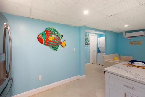 a kitchen with a fish mural on the wall at Sand Dollar Suite by Sun Palace Vacations in Fort Myers Beach