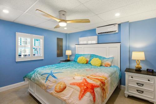 a bedroom with a bed with blue walls and a ceiling at Sand Dollar Suite by Sun Palace Vacations in Fort Myers Beach