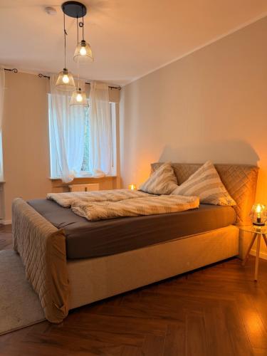 a bedroom with a large bed in front of a window at LevelUp 5von5 in Koblenz