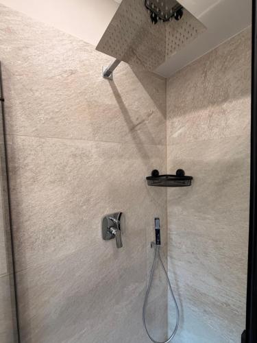 a shower with a shower head and a hose at LevelUp 5von5 in Koblenz