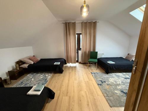 a living room with two beds and a couch at Pensjonat 33 in Szczyglice