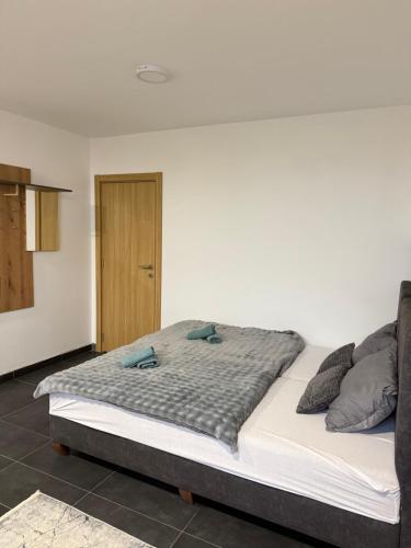 a bed with two pillows on it in a room at Lux relax apartman NS in Novi Sad