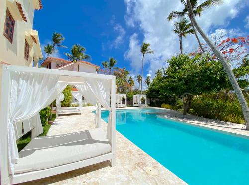 a villa with a swimming pool and a resort at Caribbean DELUXE VILLAS Los CORALES beach, POOL & SPA in Punta Cana