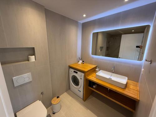 a bathroom with a washing machine and a sink at Kantouni Corfu in Potamós