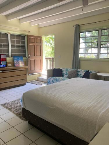 a large bedroom with a large bed and a window at King Deluxe Plus Cottage at Boundless Bliss Hotel in Raphune