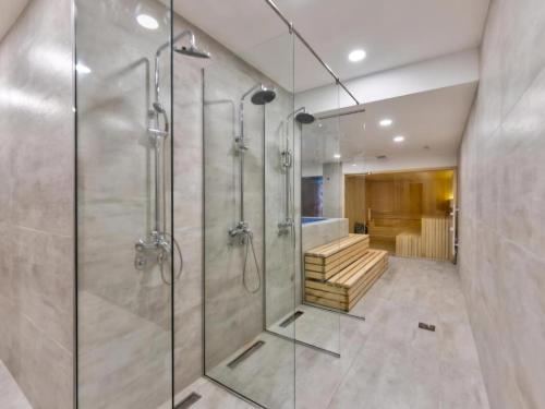 a bathroom with a walk in shower and a glass shower stall at Heli Zlatibor in Zlatibor