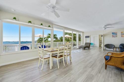 a living room with a table and chairs and a view of the ocean at Marbella Lane - Luminous Seascape Ocean View in Malae