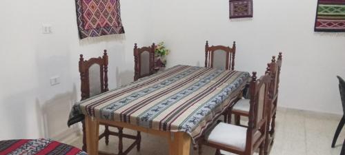 a table with chairs and a quilt on it at dar fatma matmata in Matmata