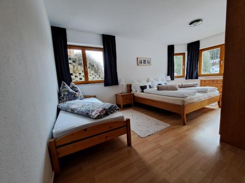 a living room with two beds and a couch at Ferienwohnung Haus Ebner in Patergassen