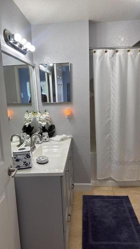 a white bathroom with a sink and a shower at Luxury house in Disney in Kissimmee