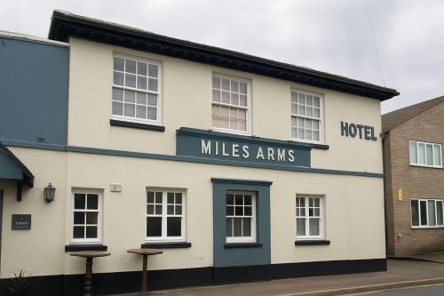 a white and blue building with a hotel miles arms at The Miles Arms Hotel in Avonmouth