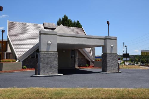 a building with an archway in a parking lot at Hawthorn Suites by Wyndham Columbia in Columbia