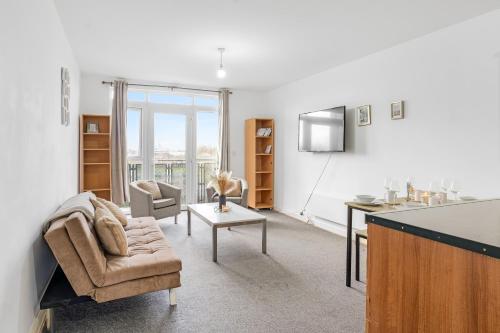 a living room with a couch and a table at City Center Base Spacious Apartment with Secure Parking in Manchester