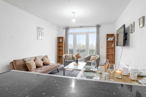a living room with a couch and a table at City Center Base Spacious Apartment with Secure Parking in Manchester