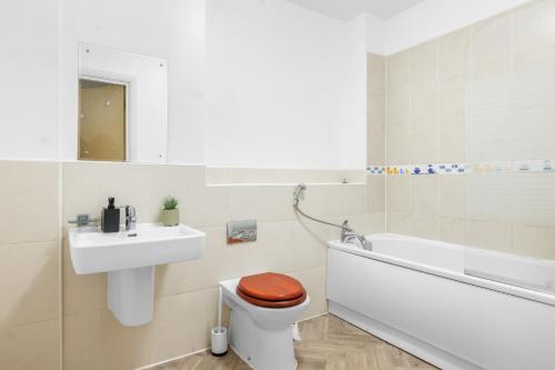 a bathroom with a toilet and a sink and a bath tub at City Center Base Spacious Apartment with Secure Parking in Manchester