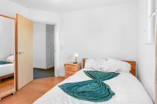 a bedroom with a white bed and a mirror at City Center Base Spacious Apartment with Secure Parking in Manchester