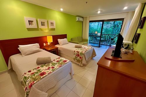 En eller flere senge i et værelse på Flat de Luxo no Costabella Marina Resort Angra