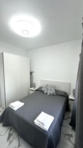 a bedroom with a bed with two towels on it at VV Abrante in La Restinga