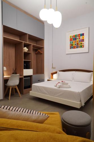 ein Schlafzimmer mit einem Bett, einem Schreibtisch und einem Stuhl in der Unterkunft Rooms Around in Neapel