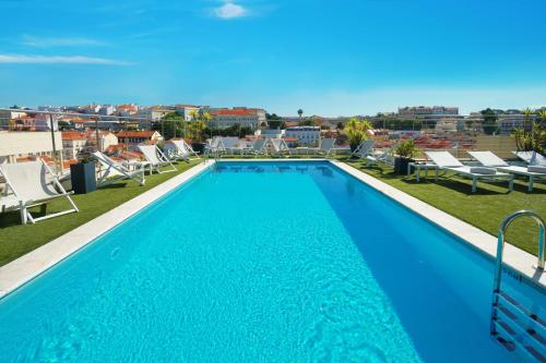 a swimming pool on the roof of a building at NH Collection Lisboa Liberdade in Lisbon