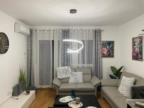 a living room with a couch and a table at Apartmani Anonim in Vrdnik