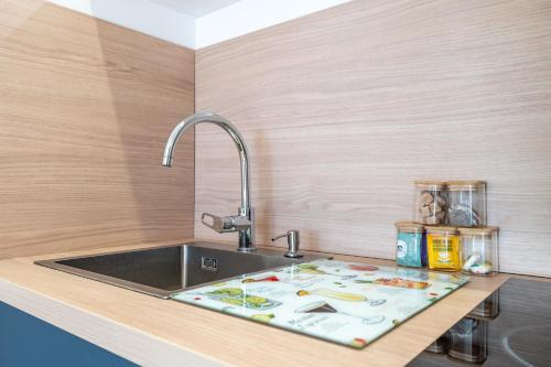 eine Küchenarbeitsplatte mit Spüle und einem digitalen Bildschirm darauf in der Unterkunft Appartement Poisy calme et résidentielle parking gratuit in Poisy