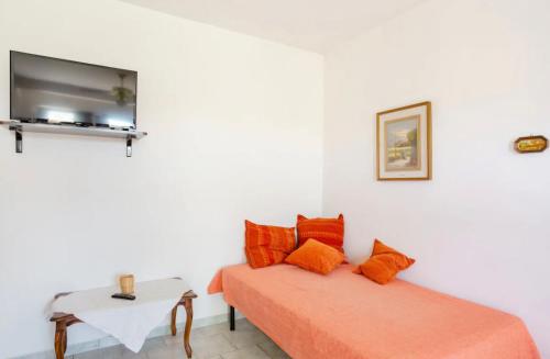 um quarto com duas camas e uma tv na parede em Appartamento con giardino em Pomarance