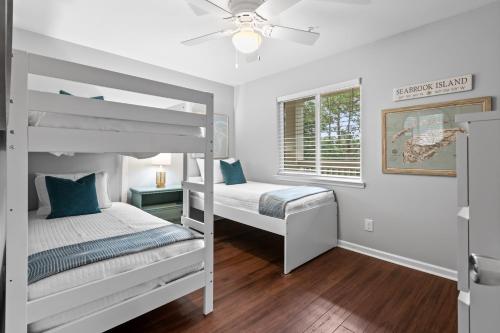 a bedroom with two bunk beds and a window at 2017 Marsh Walk Villa in Summerville