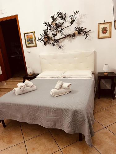 a bedroom with a bed with two towels on it at L'ulivo - A due passi dal Mare in Mola di Bari