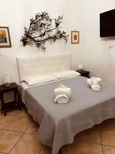 a bedroom with a bed with towels on it at L'ulivo - A due passi dal Mare in Mola di Bari