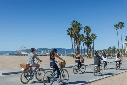 a group of people riding bikes on the beach at Casa Del Mar in Los Angeles