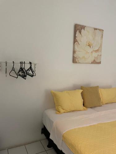 a bedroom with a bed with two lights on the wall at Tropical Harbour View in Monchy