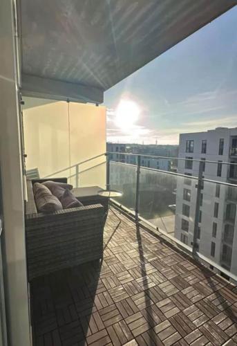a balcony with a bed on top of a building at Odense Habor with access to the harbor sauna and pool in Odense