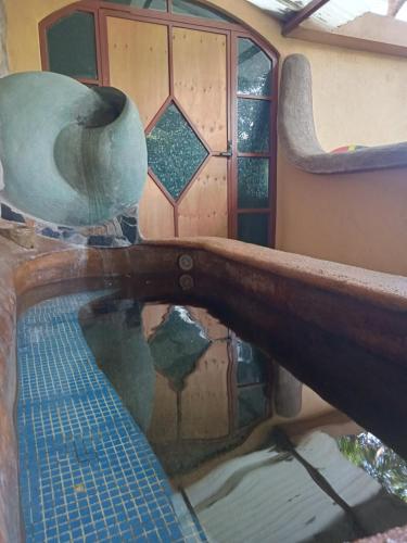 a reflection of a mirror in a room with a window at Casa Musgo in Xilitla