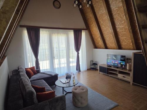 Monte Village في نيكشيتش: غرفة معيشة مع أريكة وتلفزيون