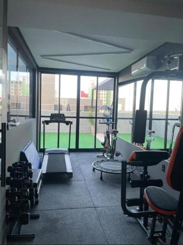 a gym with a bunch of equipment in a room at Flat Beach Way caminho da praia in Cabedelo