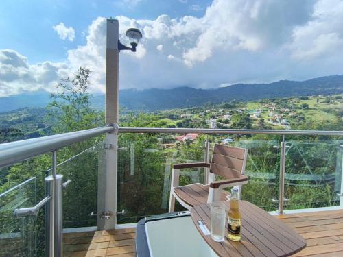 a balcony with a table and a lamp and a view at Glamping Guacharaca Silvanía Cundinamarca in Silvania