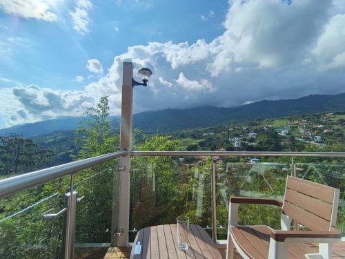 a balcony with a light and a table and a chair at Glamping Guacharaca Silvanía Cundinamarca in Silvania