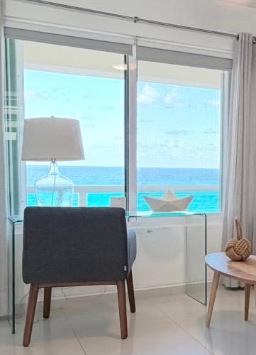 a living room with a view of the ocean at Beachfront Three-Story Coastal Penthouse, 3BR-3BA in Cancún