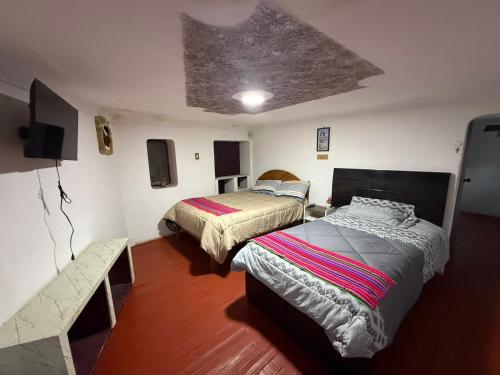 Кровать или кровати в номере QOLLA WASI - Santa Ana