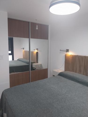 a bedroom with a large mirror and a bed at Las Pircas PB in Alta Gracia